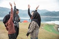 Group of friends meeting and rise hand enjoy lake view