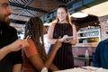 Friends ordering food to the waitress at a restaurant.