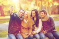 Group of friends with photo camera in autumn park Royalty Free Stock Photo