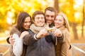 Group of friends with photo camera in autumn park Royalty Free Stock Photo