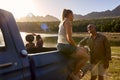 Group Of Friends In Pick Up Truck On Road Trip By Lake At Sunset Royalty Free Stock Photo