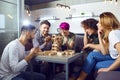 A group of friends play board games in the room.