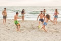 Group of friends playing with ball on the beach Royalty Free Stock Photo