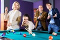 Group of friends playing billiards Royalty Free Stock Photo