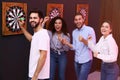 Group of friends playing darts