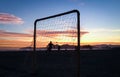 Group of friends playing football on the beach during a magnificent summer sunset in Santos