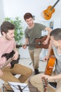 Group friends playing guitar at home Royalty Free Stock Photo