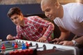 Group of friends playing table soccer at beer pub Royalty Free Stock Photo