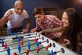 Group of friends playing table soccer at beer pub Royalty Free Stock Photo