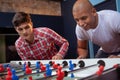 Group of friends playing table soccer at beer pub Royalty Free Stock Photo