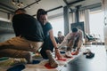 Group of friends playing twister game together in a cozy room Royalty Free Stock Photo