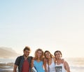 group of friends posing on beach having fun summer vacation lifestyle on seaside at sunset Royalty Free Stock Photo