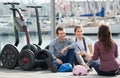 Group of friends posing near segways on shore