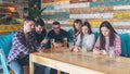 Group of friends at pub ignoring each other in favour of mobile phone Royalty Free Stock Photo