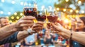 Group of friends raising glasses of red wine in a toast at a summer outdoor gathering Royalty Free Stock Photo