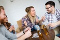 Group of friends relaxing and hanging out together while playing cards Royalty Free Stock Photo