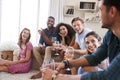 Group Of Friends Relaxing At Home And Drinking Wine Together Royalty Free Stock Photo