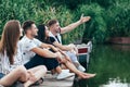 Group of friends relaxing on lake. Royalty Free Stock Photo