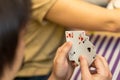 Group of friends relaxing and playing cards together. Royalty Free Stock Photo