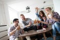 Group of friends relaxing and playing cards together. Young people hanging out together Royalty Free Stock Photo