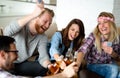 Group of friends relaxing and playing cards together. Young people hanging out together Royalty Free Stock Photo