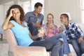 Group Of Friends Relaxing On Sofa Drinking Wine At Home Together Royalty Free Stock Photo