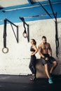 Friends relaxing and taking a break after working out at a cross-training gym Royalty Free Stock Photo