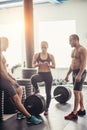 Friends relaxing and taking a break after working out at a cross-training gym Royalty Free Stock Photo