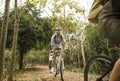 Group of friends ride mountain bike in the forest together Royalty Free Stock Photo