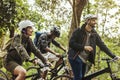 Group of friends ride mountain bike in the forest together Royalty Free Stock Photo