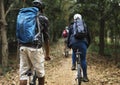 Group of friends ride mountain bike in the forest together Royalty Free Stock Photo