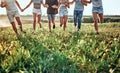 Group of friends running on grass meadow on country side Royalty Free Stock Photo