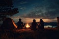 Group of friends sitting around campfire at night and looking at starry sky, Friends enjoying a summer camping, top section
