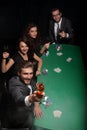 Group of friends sitting at a casino table Royalty Free Stock Photo