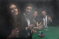 Group of friends sitting at game table in casino Royalty Free Stock Photo