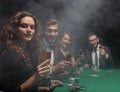 Group of friends sitting at game table in casino Royalty Free Stock Photo