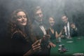 Group of friends sitting at game table in casino Royalty Free Stock Photo