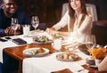 Group of friends enjoying an evening meal at a restaurant. Royalty Free Stock Photo