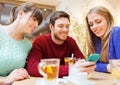 Group of friends with smartphone meeting at cafe