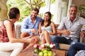 Group of friends socialising in a conservatory Royalty Free Stock Photo