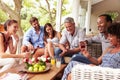 Group of friends socialising in a conservatory Royalty Free Stock Photo