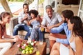 Group of friends socialising in a conservatory Royalty Free Stock Photo