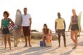Group of friends standing and looking at camera at beach on a sunny day Royalty Free Stock Photo