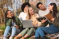 Group of friends students studying at autumn park Royalty Free Stock Photo