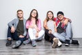Young group of friends students teengers sitting on floor Royalty Free Stock Photo