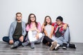 Young group of friends students teengers sitting on floor Royalty Free Stock Photo