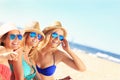 Group of friends sunbathing on the beach Royalty Free Stock Photo