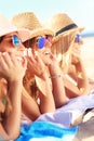 Group of friends sunbathing on the beach Royalty Free Stock Photo