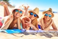 Group of friends sunbathing on the beach Royalty Free Stock Photo