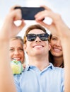 Group of friends taking picture with smartphone Royalty Free Stock Photo